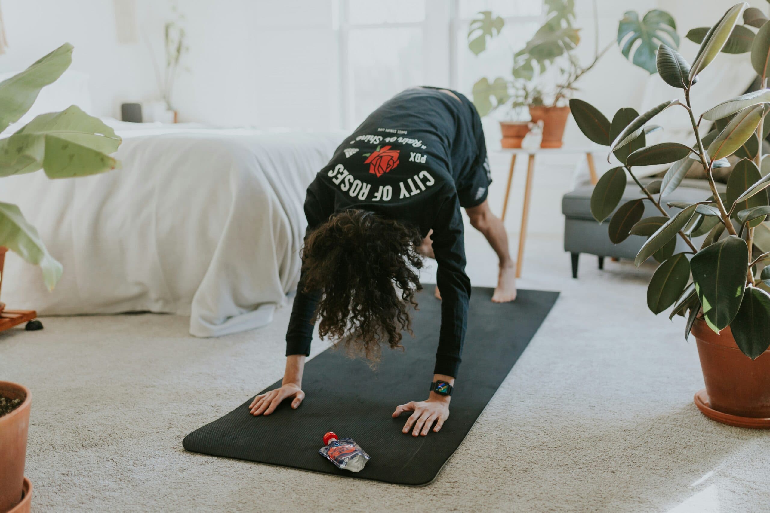 woman doing stretches atop a yoga mat