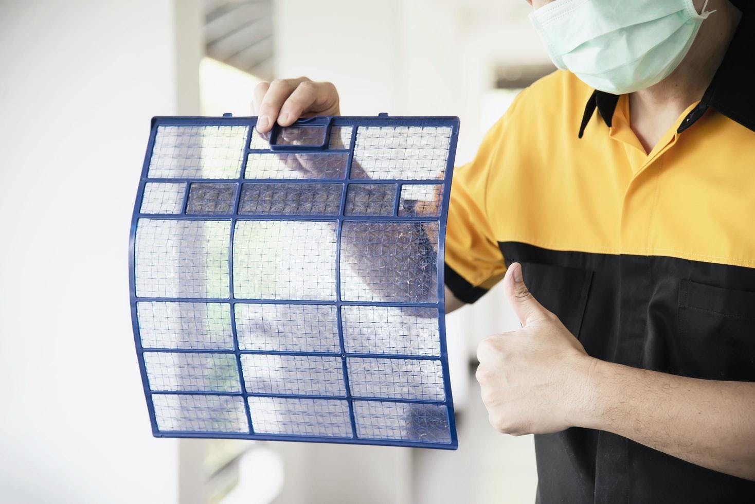 aircon technician showing clean filters