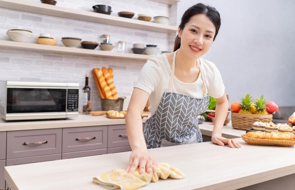Helper cleaning kitchen after cooking