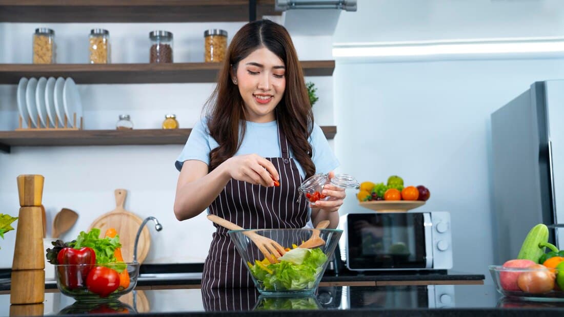 Part-time helper making salad