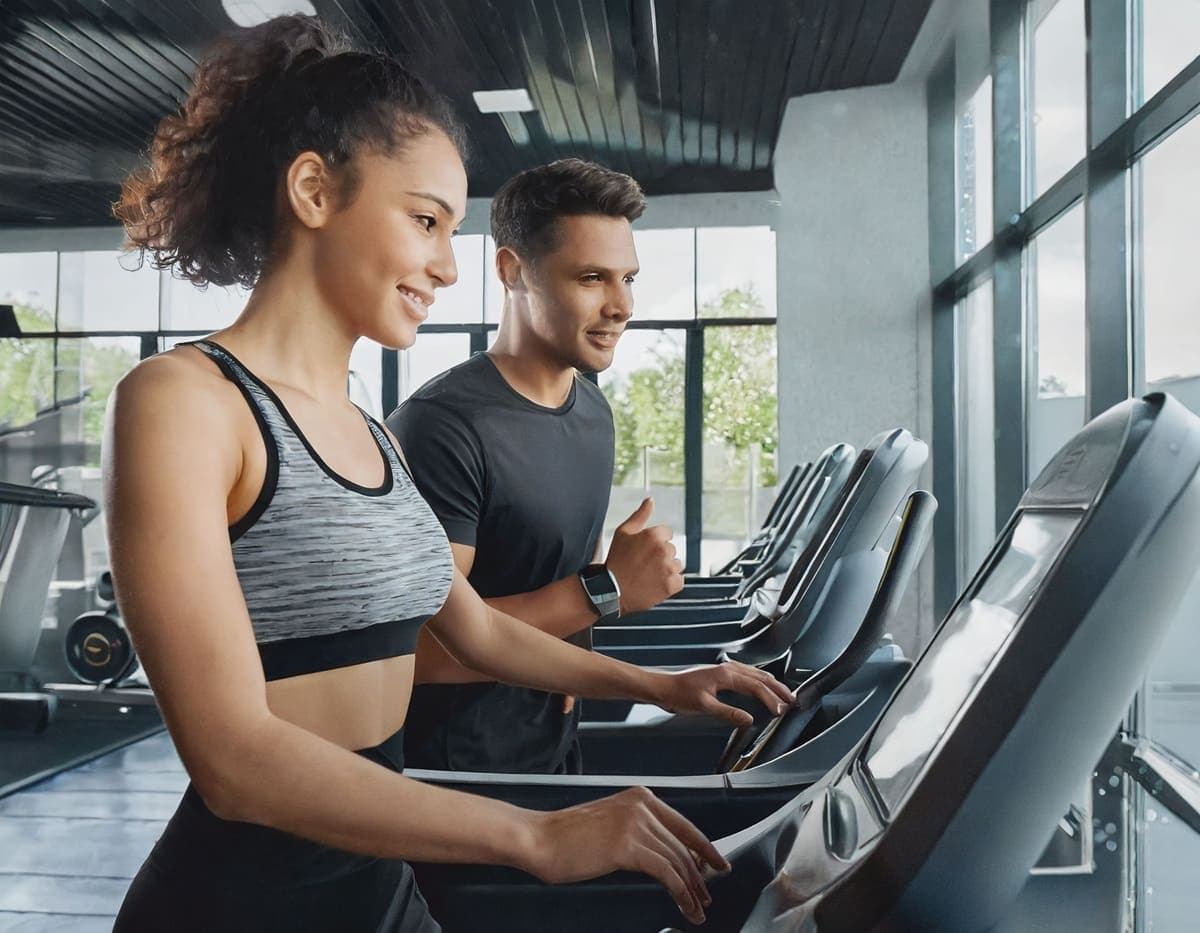 Personal trainer coaching on treadmill